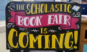 A picture of a sign that says the book fair is coming